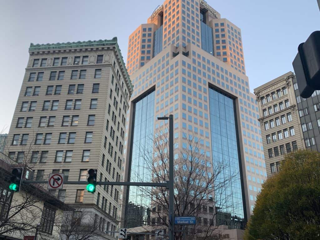 A tall building with a green light in front of it occupied by an employment lawyer.