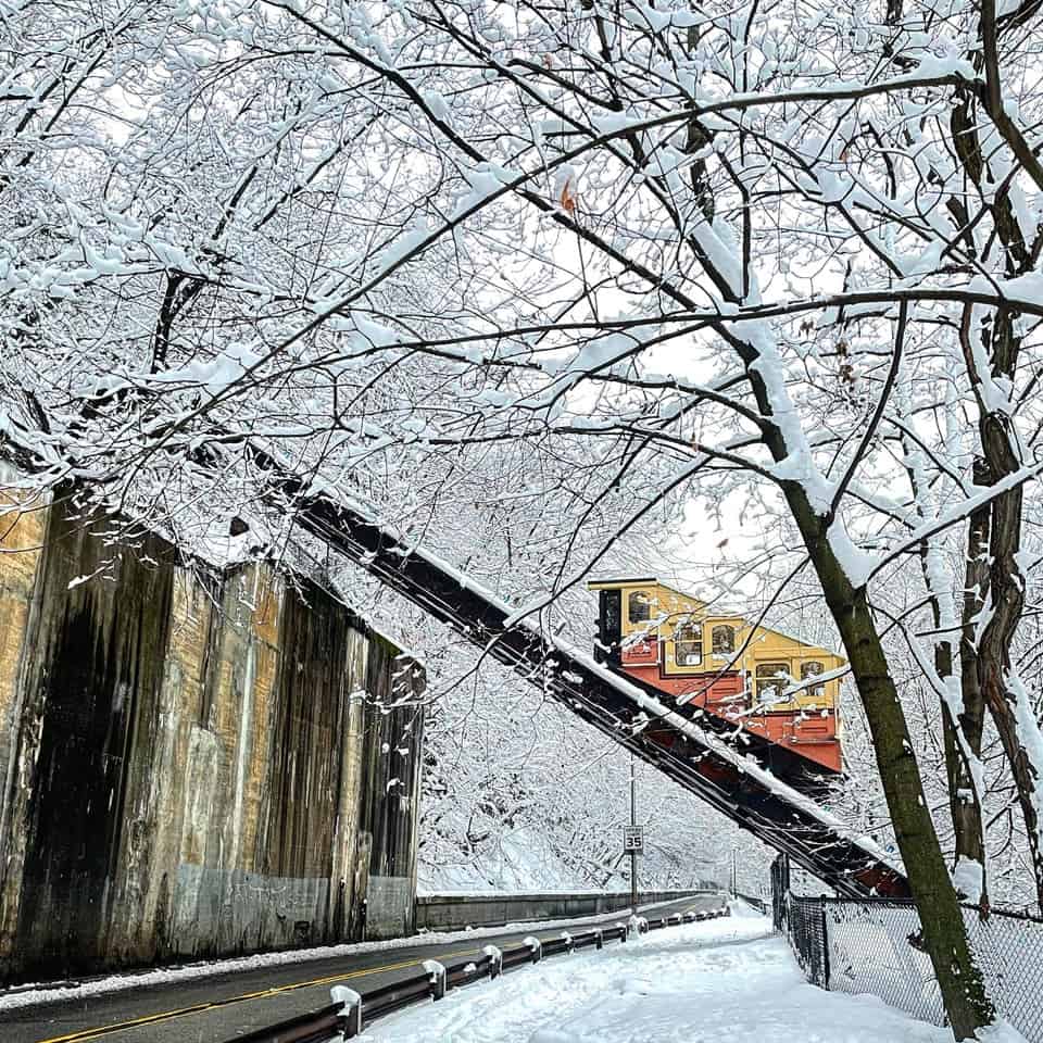 A train traveling down a snow covered road.