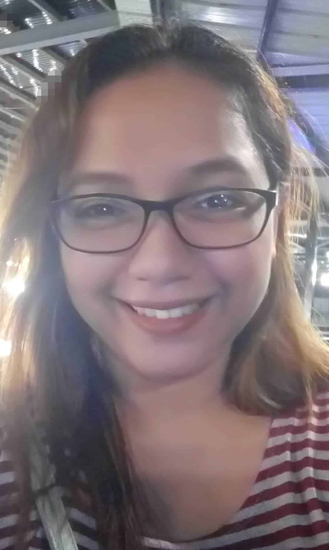 A woman wearing glasses and a striped shirt is an employment lawyer.