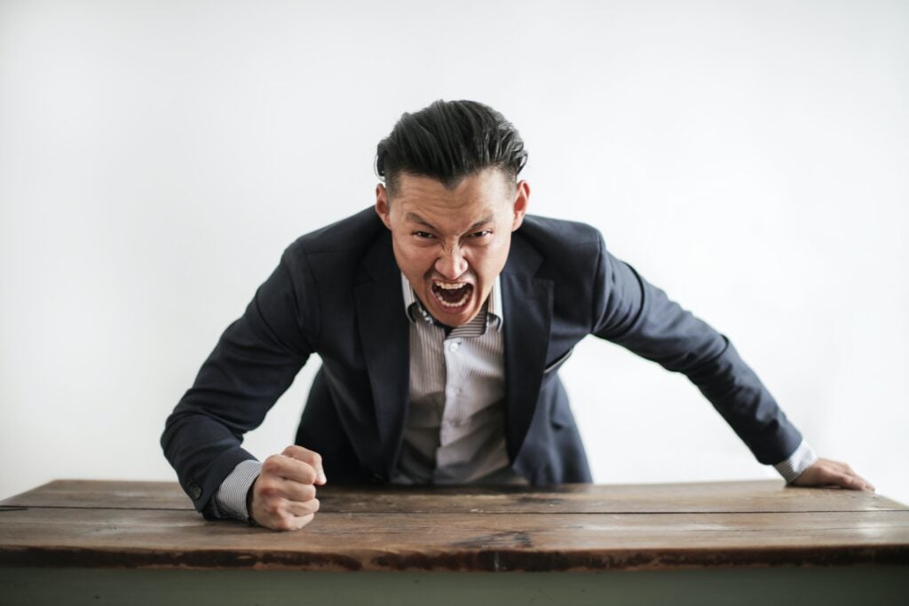 An employment lawyer is arguing with a wooden table.