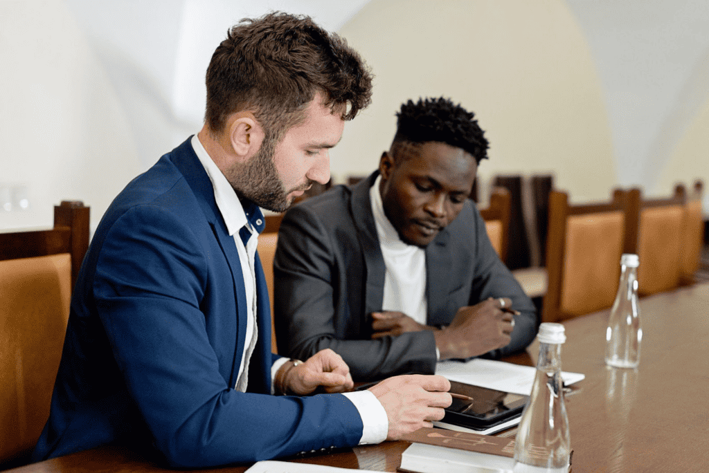 Two employment lawyers in suits sitting at a conference table.