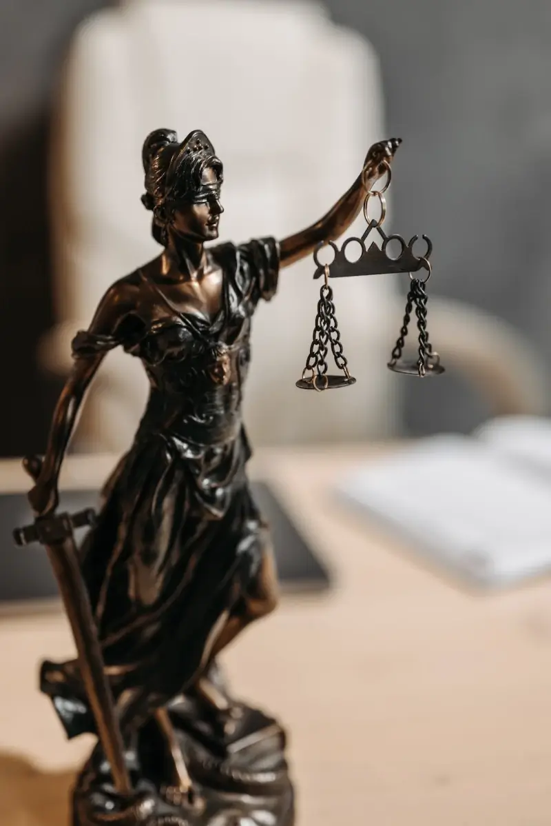 Bronze statue of Lady Justice, echoing the dedication of an NJ employment lawyer, holds a sword and balance scales, symbolizing law and fairness.